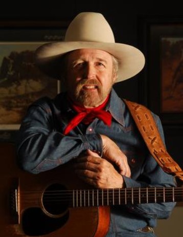 Photo of Cowboy Balladeer Tom Hiatt holding his guitar