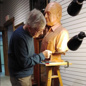 Ross Provence Artist Sculptor working on a clay bust of Olaf Wieghorst at the Wieghorst Museum
